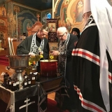 Priests pour ingredients into container in which they will be heated and stirred for three days