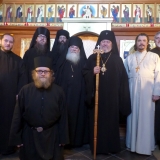 Standing: Deacon Alexander Treiger, Rassophore-monk Cyprian, Hieromonk Cassian, Igumen Roman, Archbishop Irénée, Archpriest Nazari, Deacon Nicholas Kneeling: Novice Spyridon