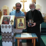 Longtime Mission member Darcy Tkachuk and Fr. John Gryba, resident priest, hold these great spiritual gifts, the icon and relic