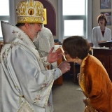 Vladika Irénée présente la croix à la présidente de la paroisse, Karen Davis